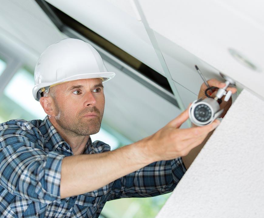 Technician Installing CCTV System in Atlanta, GA Commercial Property