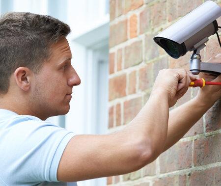 a man installing a Home Security Systems in Canton, GA, Kennesaw, Sandy Springs, Brookhaven, GA, Alpharetta, Atlanta