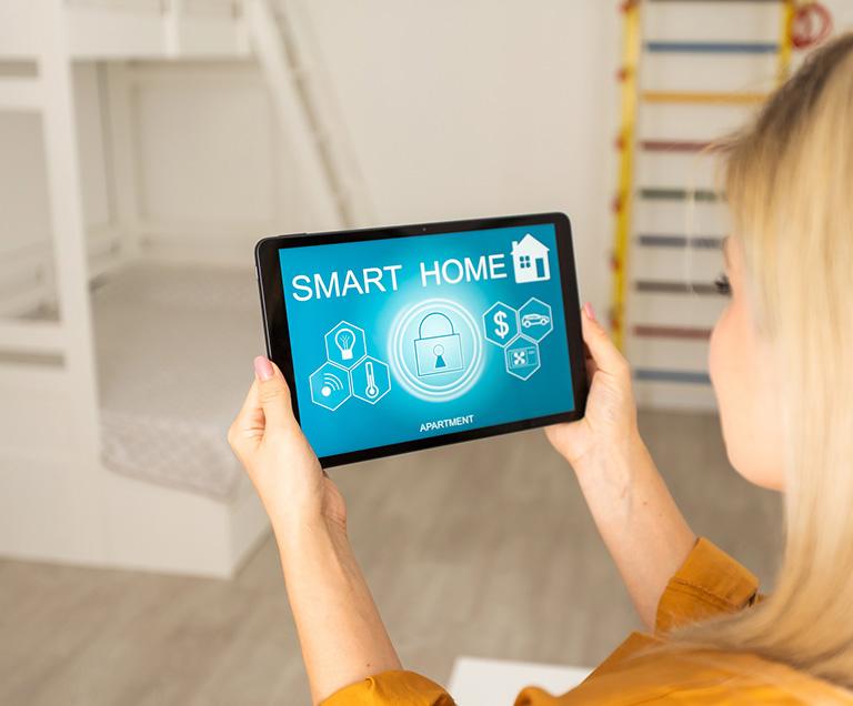 lady using smart home application on her tablet